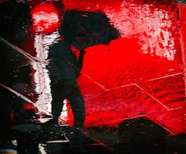 a person holding an umbrella in the rain