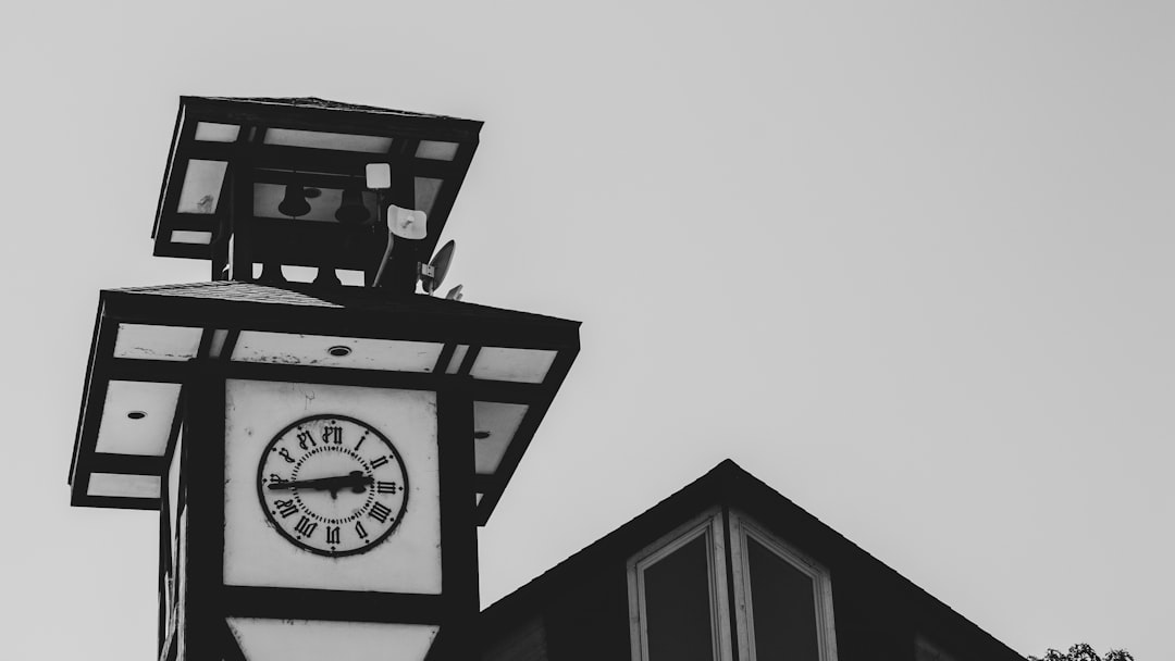 grayscale photography of a tower clock