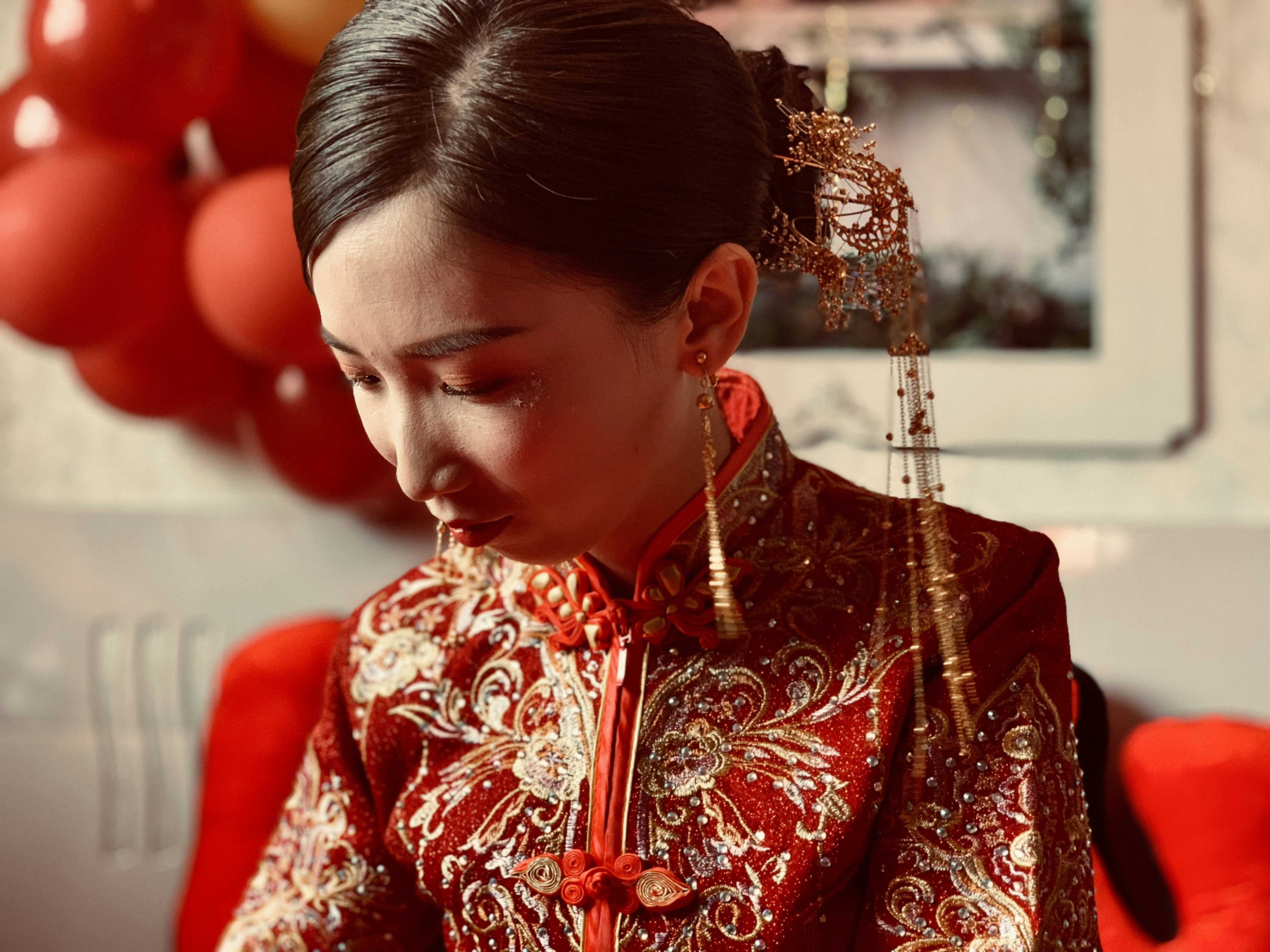 woman in brown and red floral traditional dress
