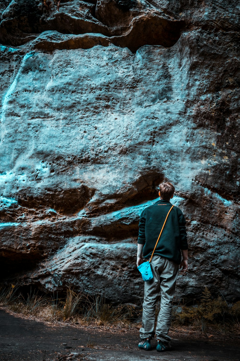 man standing facing mountain