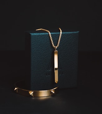 gold-colored pendant necklace