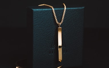gold-colored pendant necklace