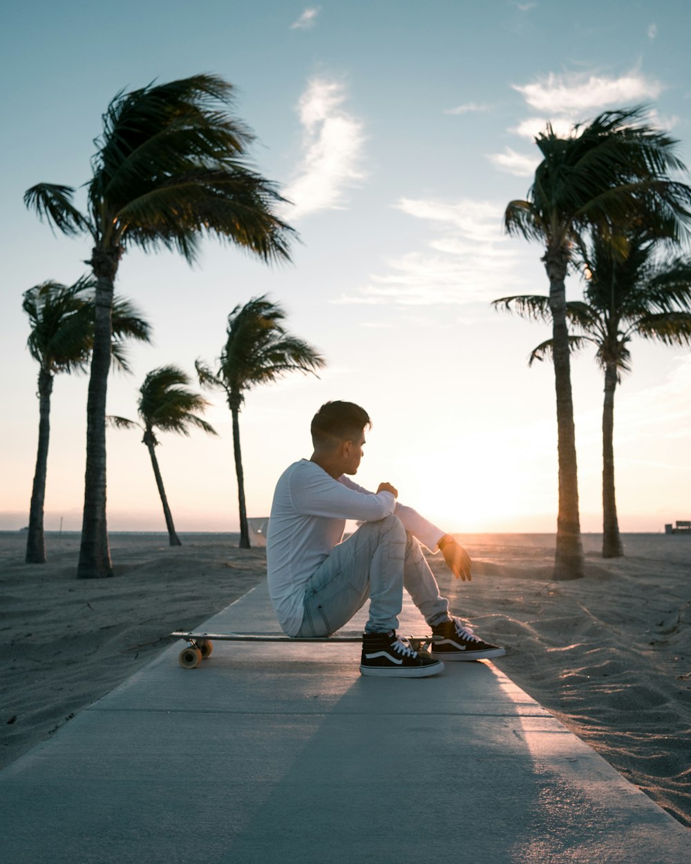 man sitting on skateboard