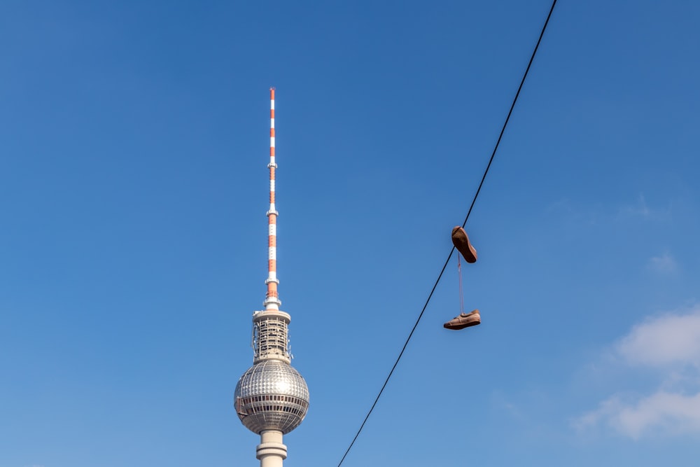 pair of brown shoes on cable wire