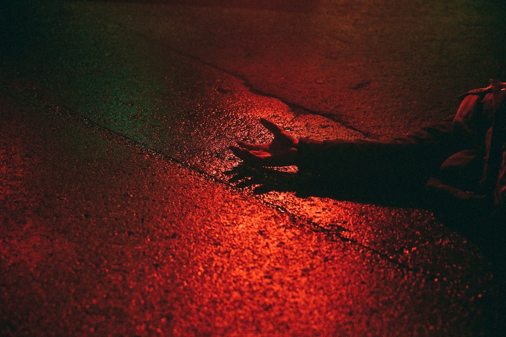 a person laying on the ground in the street