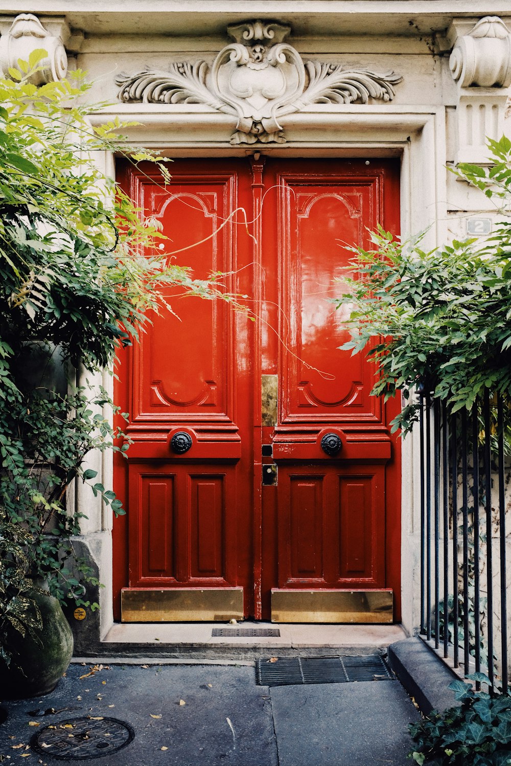 white building showing closed red wooden door