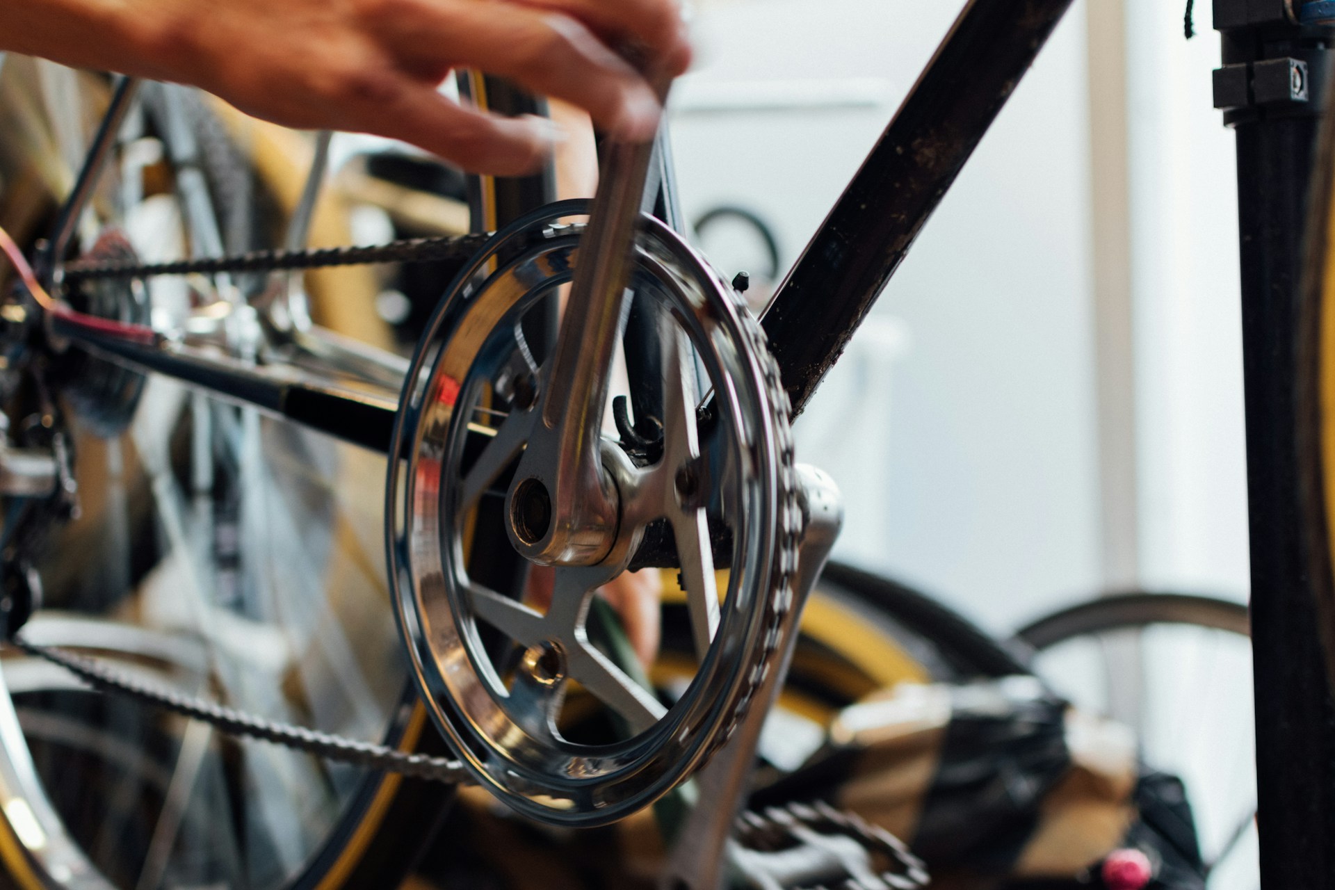 A close-up of a bicycle mechanic working on a bike, showcasing expertise and attention to detail.