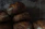 Close-up of freshly baked rustic bread loaves stacked on a wooden counter.