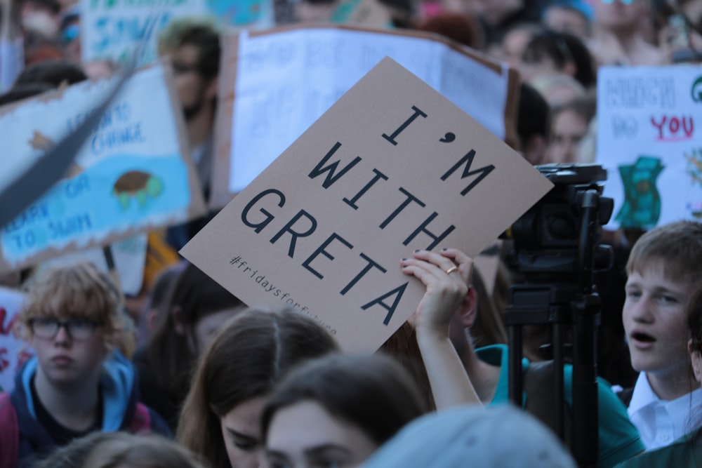 person holding I'm with Greta signage