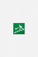 A green emergency exit sign featuring a white pictogram of a person descending stairs with an arrow pointing downwards and to the left.