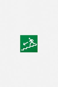 A green emergency exit sign featuring a white pictogram of a person descending stairs with an arrow pointing downwards and to the left.