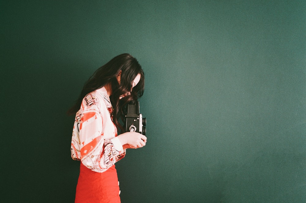 woman holding black camera