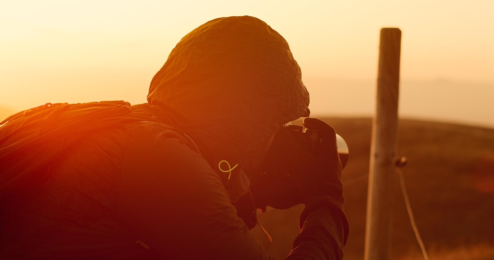 man taking shots during golden hour