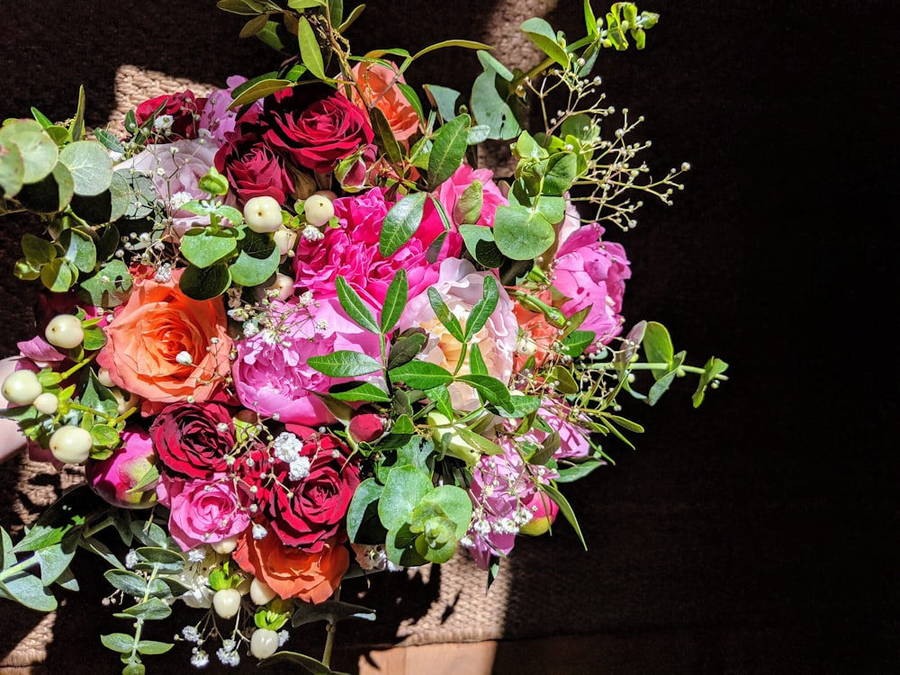 orange, pink, and red rose flower bouquet