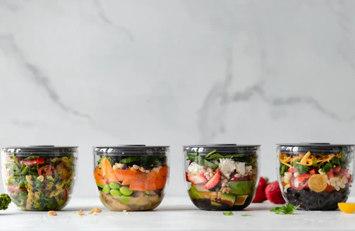 Assorted ready-to-serve salads in clear trays, perfect for horeca use
