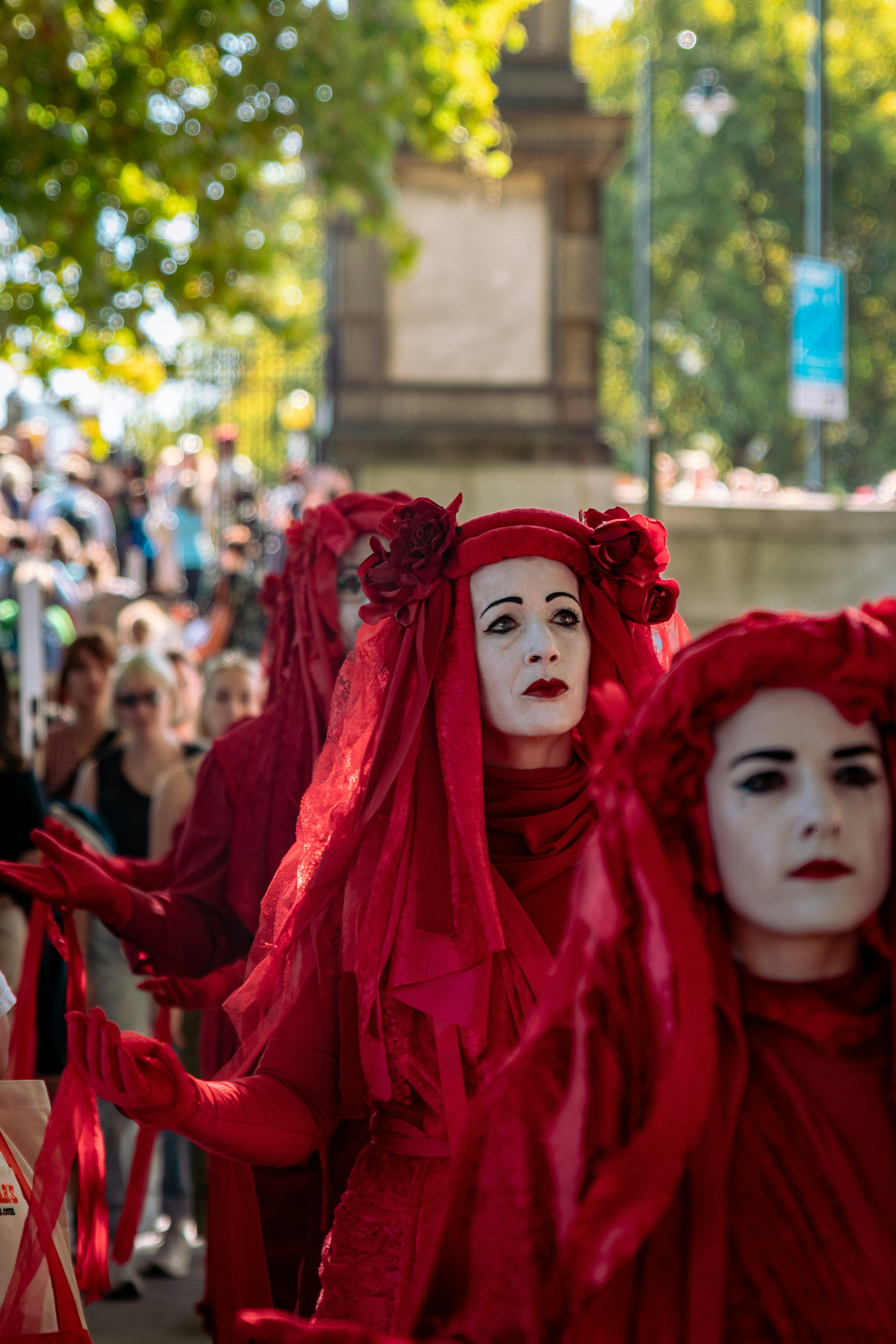 Performers dressed in red during a global strike for climate change.