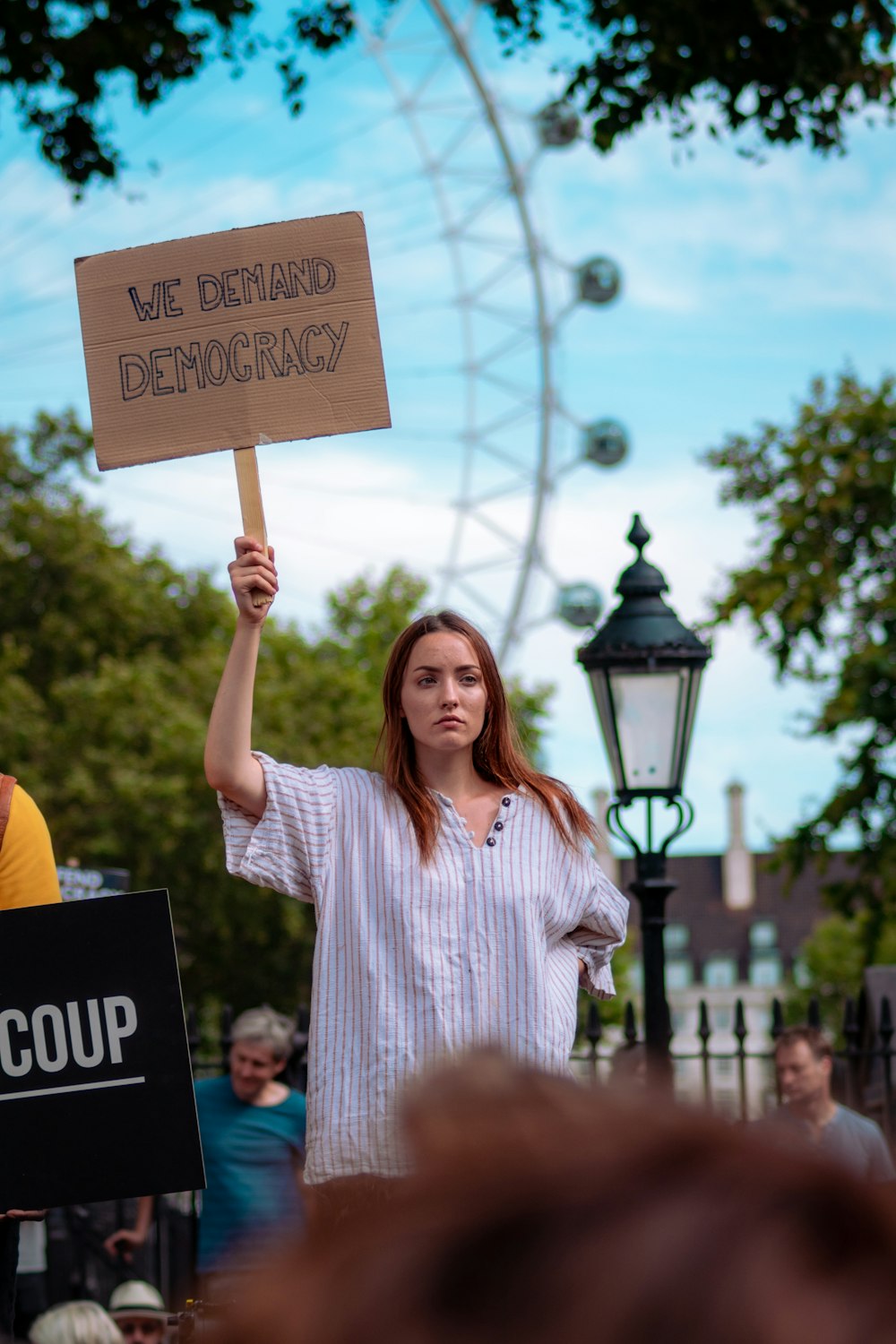 woman holding signboard