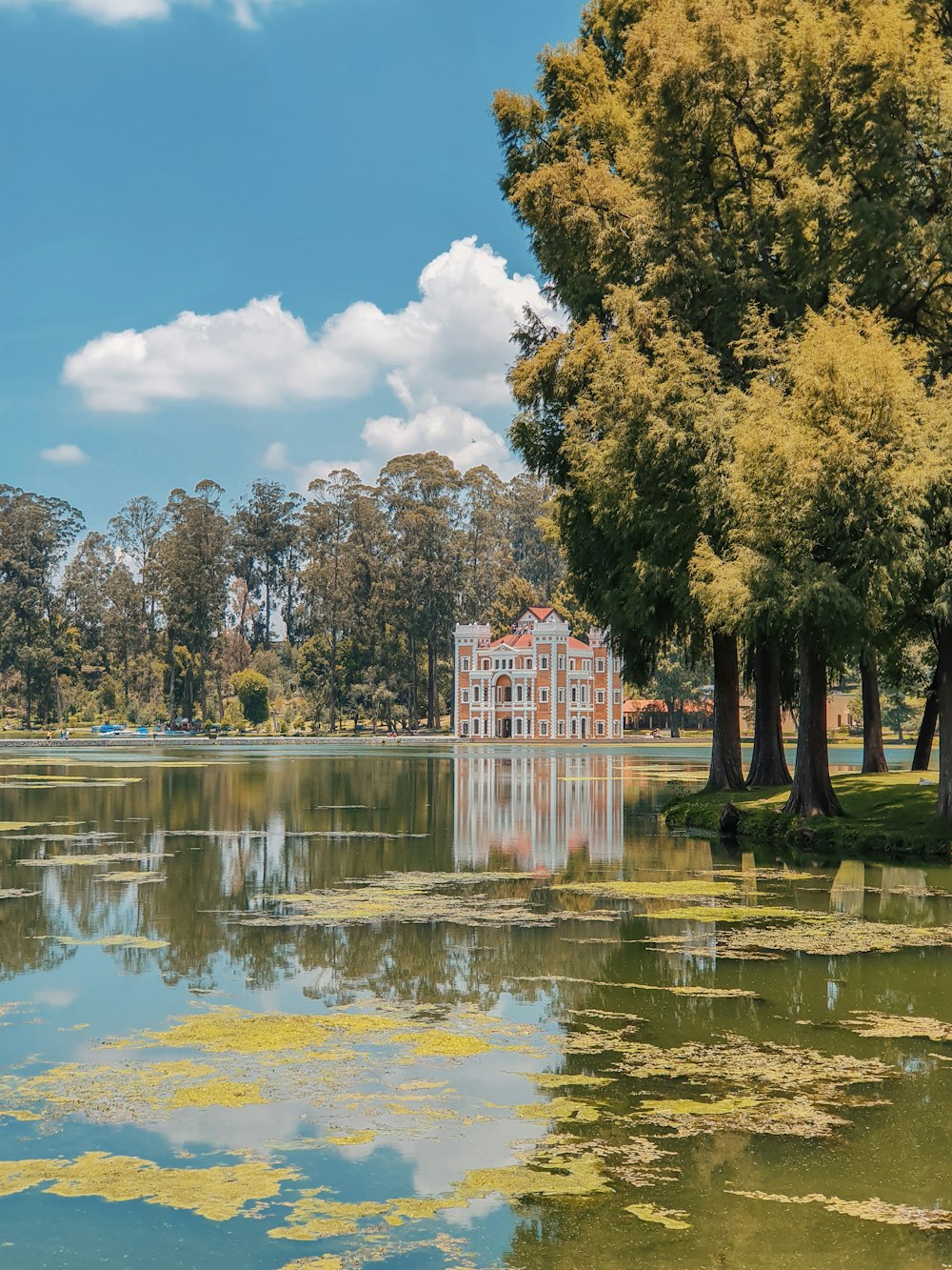 white and orange concrete house near body of water