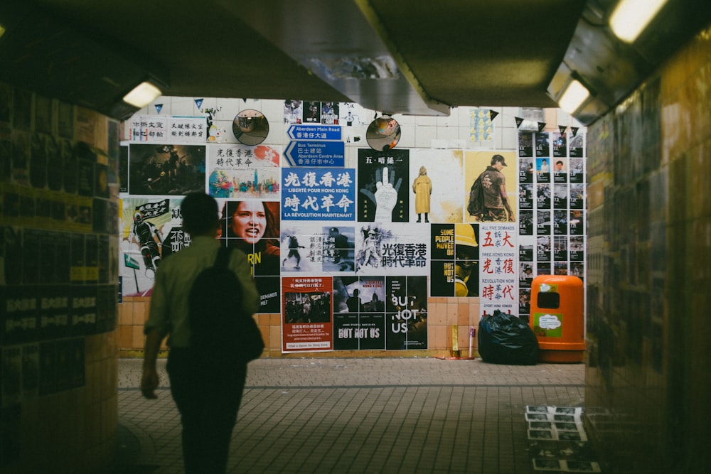 person walking towards wall art