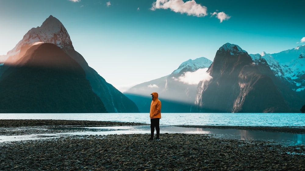 man standing near body of water