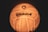 A close-up view of a ball with the logo 'Spikeball' visible on its surface. The ball appears to be illuminated with a warm, yellow-orange glow, accentuating its texture and design.