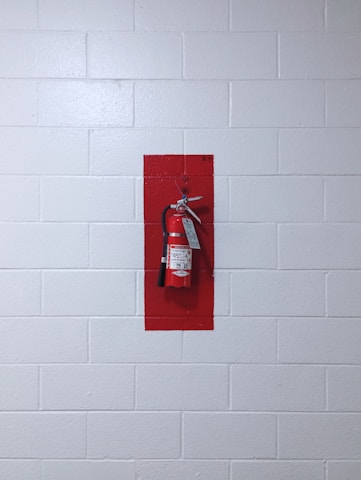 red fire extinguisher on wall