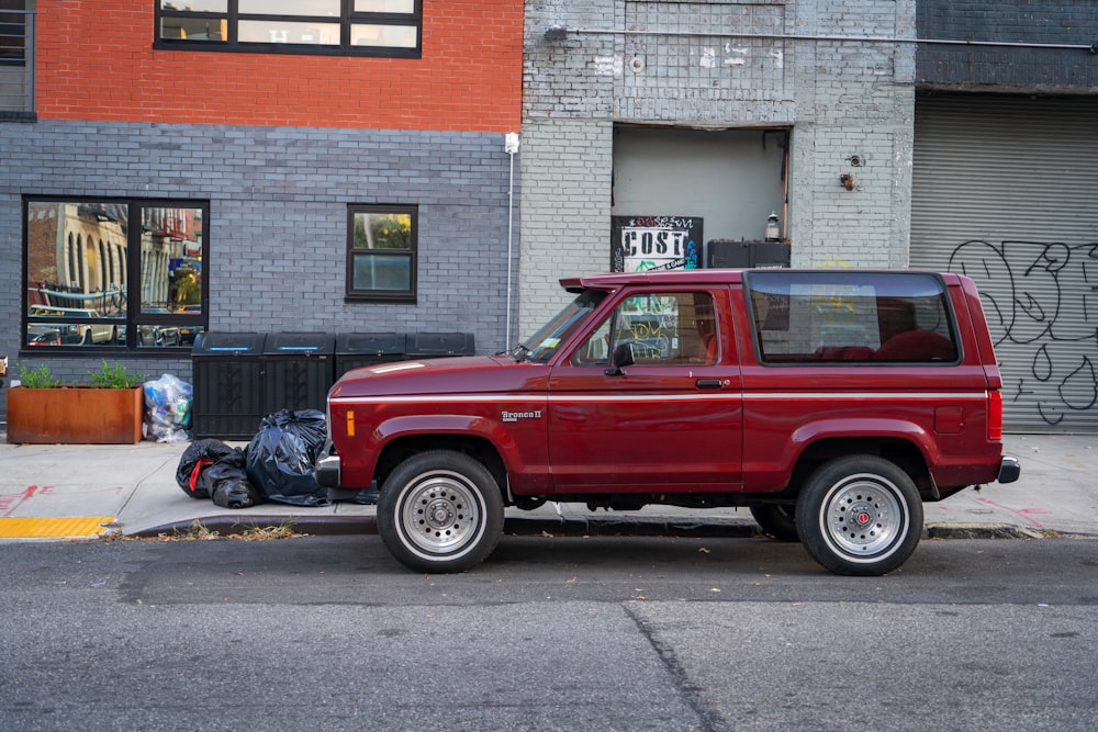 red single cab pickup truck with camper shell