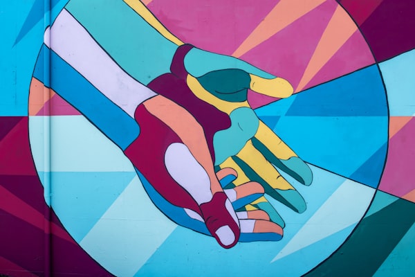 a colorful geometric drawing of outstretched hands, palms open