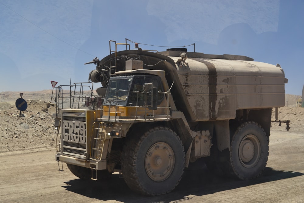 gray truck on dirt road during day