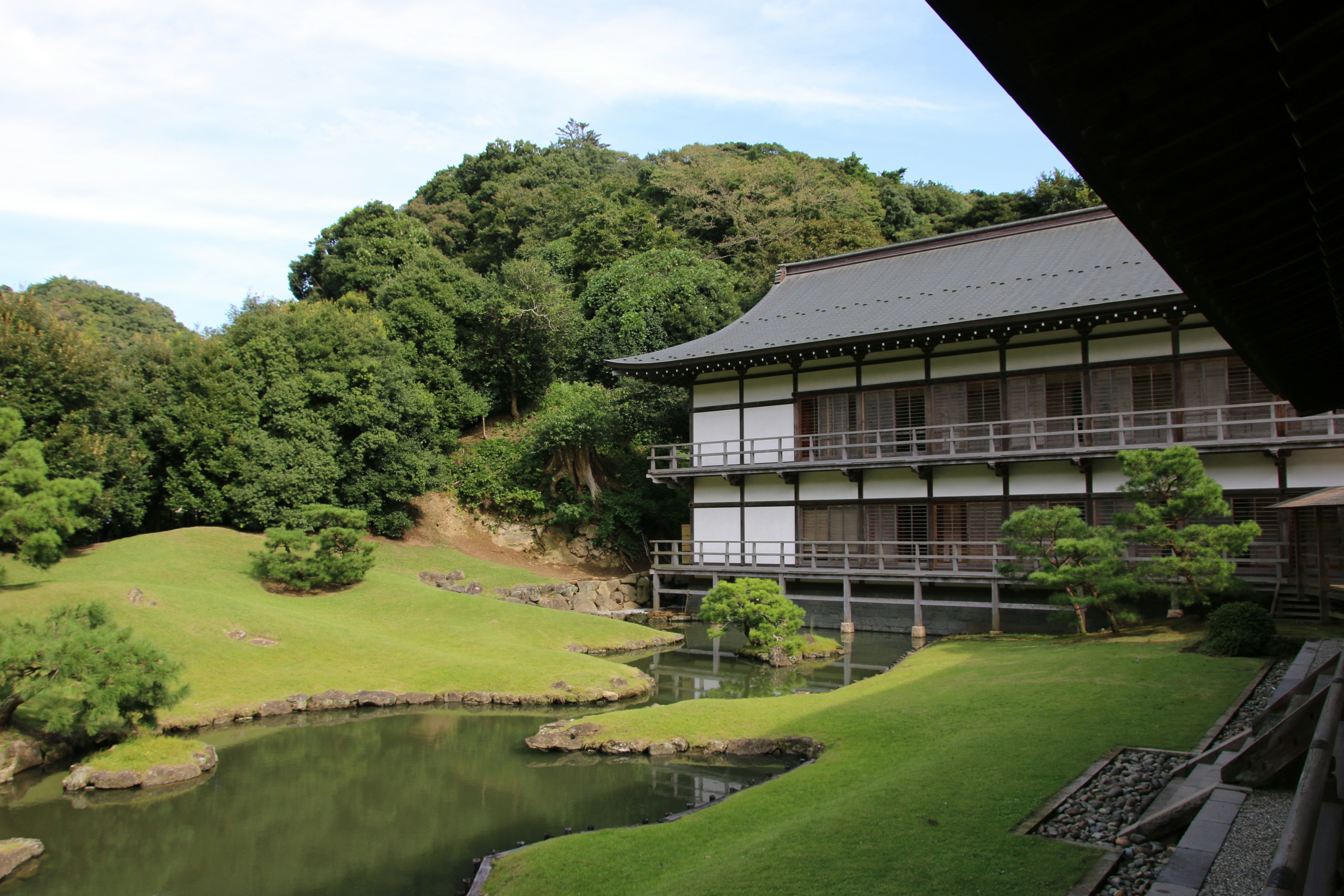 gray concrete temple beside trees at daytime