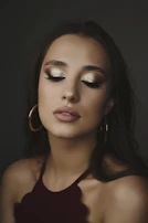 A stylish party makeup look featuring subtle rose gold eyeshadow and nude lips.