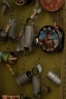 An assortment of rustic collectible pieces displayed on a brushed metal surface with subtle aged cream highlights.
