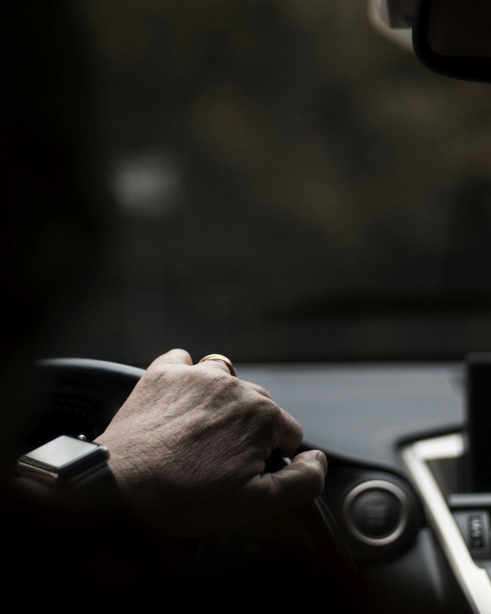 person gripping on steering wheel