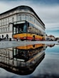 yellow parked bus near building