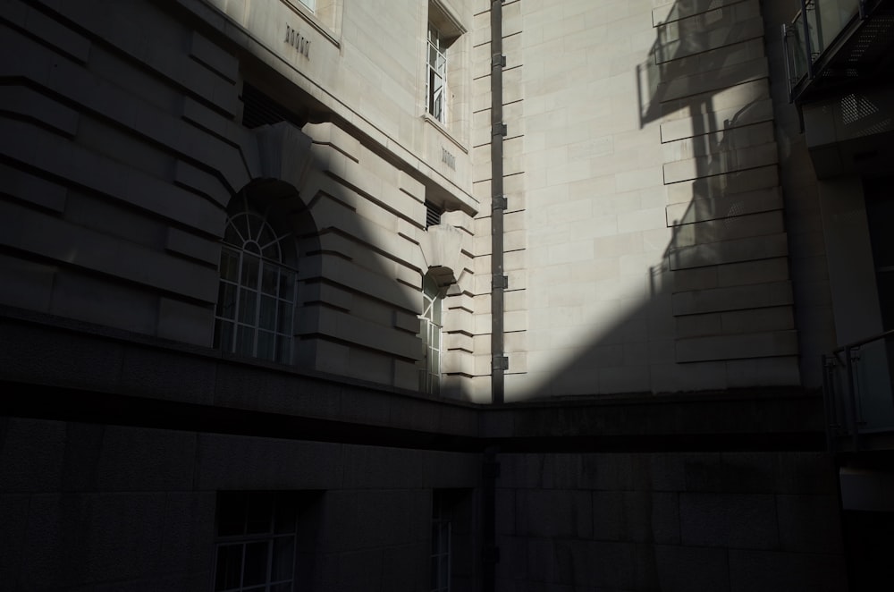 the shadow of a building on the side of a street