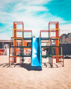 Bright playground installation team assembling colorful kidplay structure outdoors.