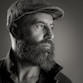 a black and white photo of a man with a beard