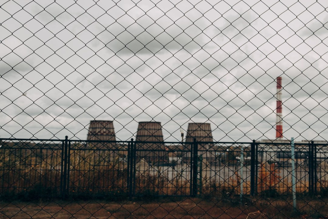 three brown factory chimneys during daytime