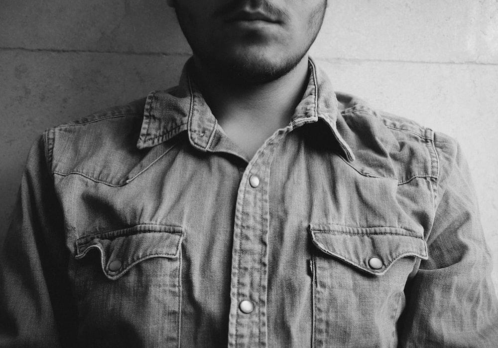 grayscale photography of man wearing gray collared shirt