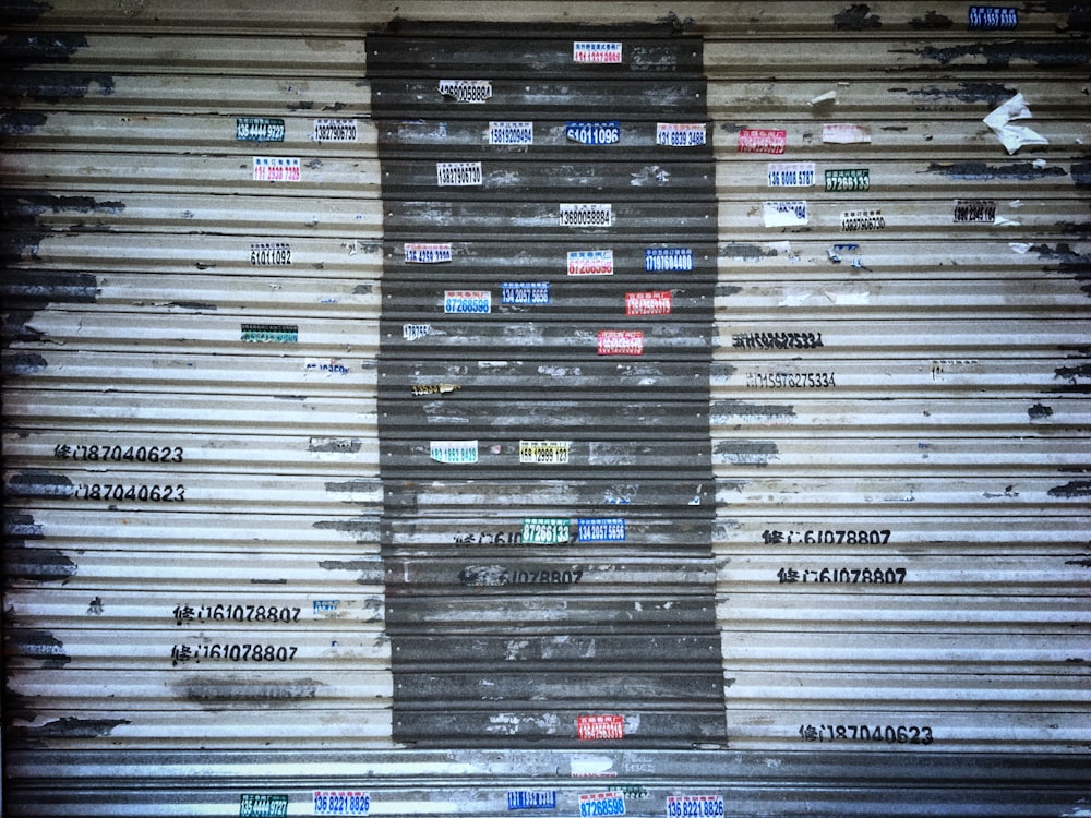 a metal door with a lot of stickers on it