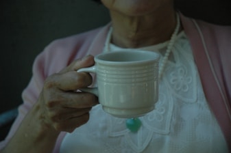 woman holding white cup