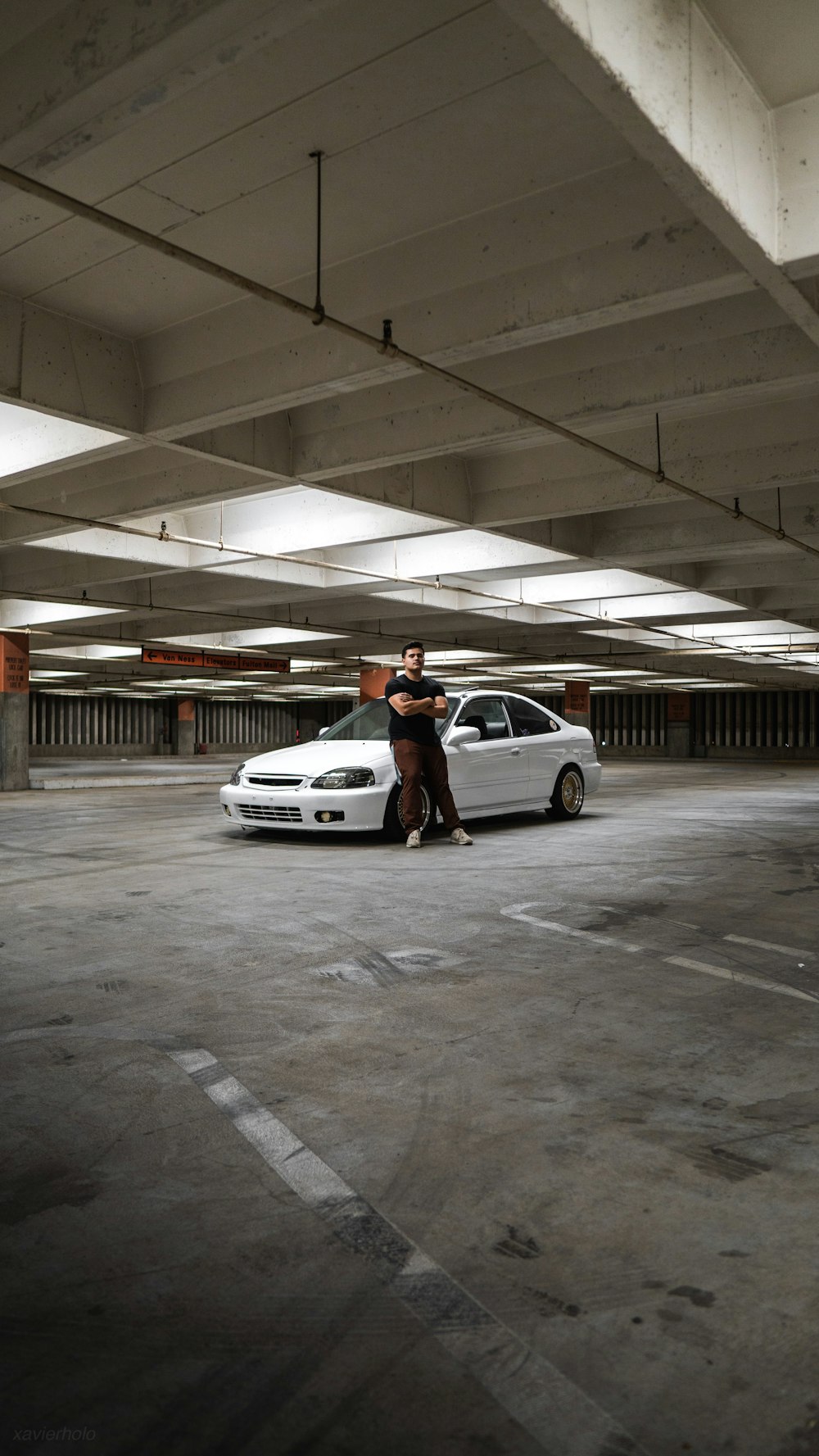 man standing near the white vehicle