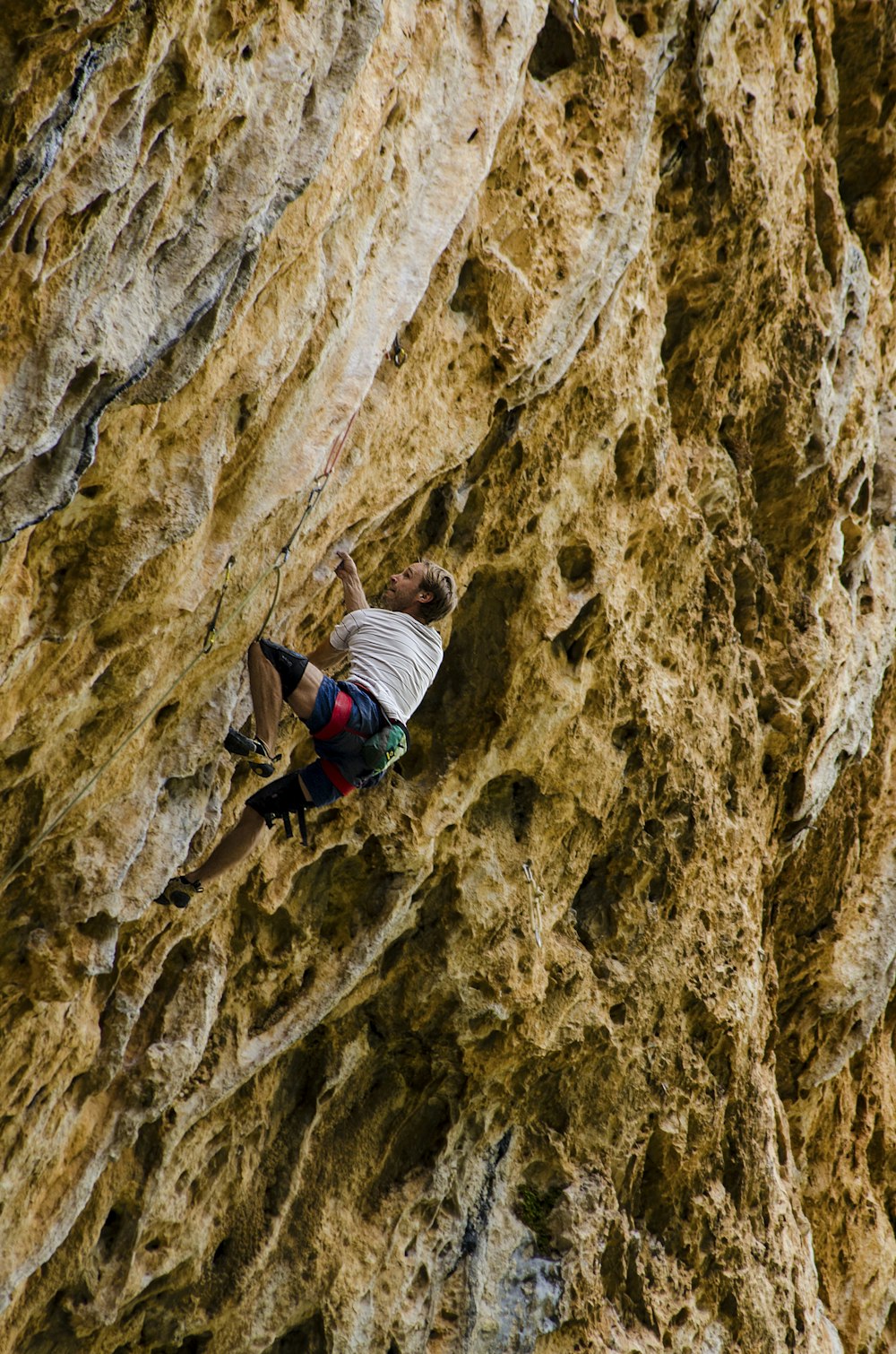 man climbing on rock mountain