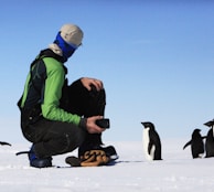 man near penguins