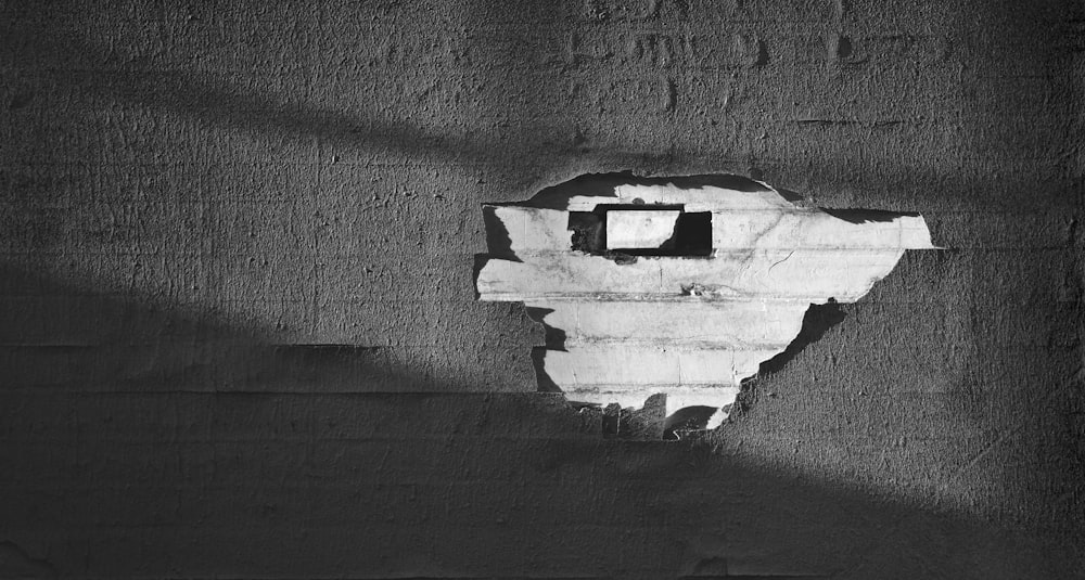 a black and white photo of a hole in a wall