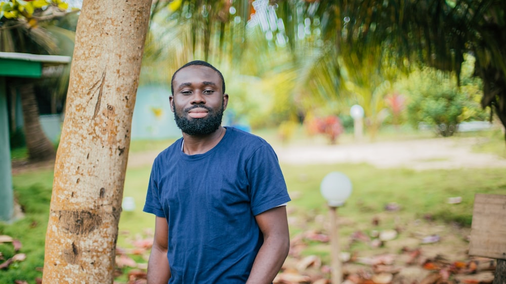 man standing beside tree