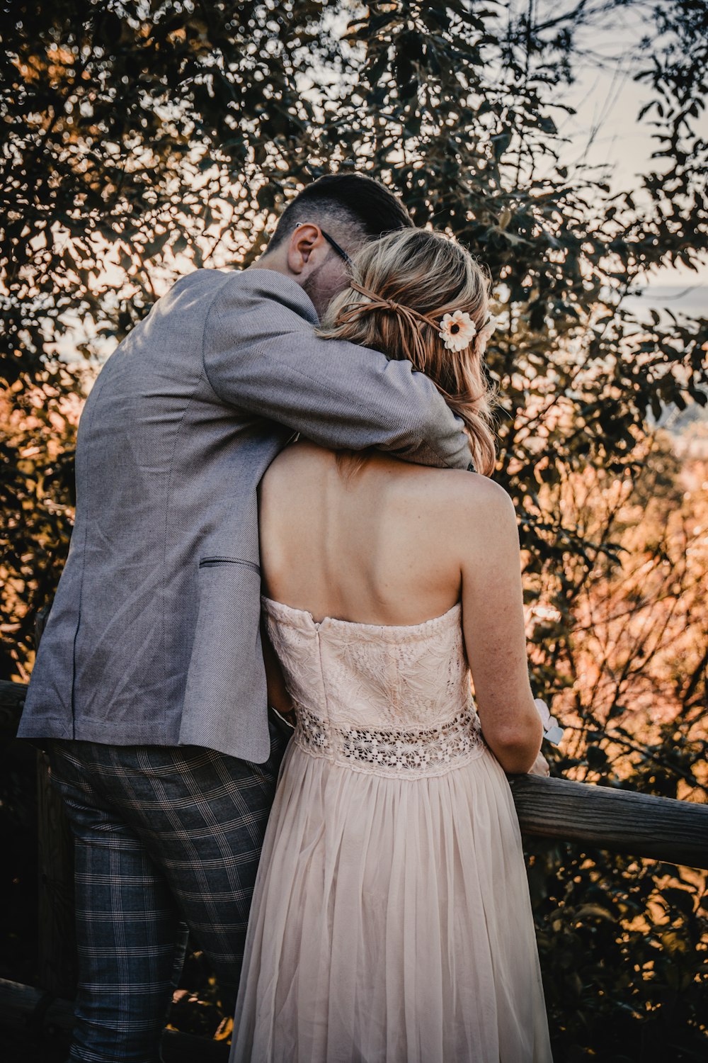 couple standing near green leafed trees during daytime