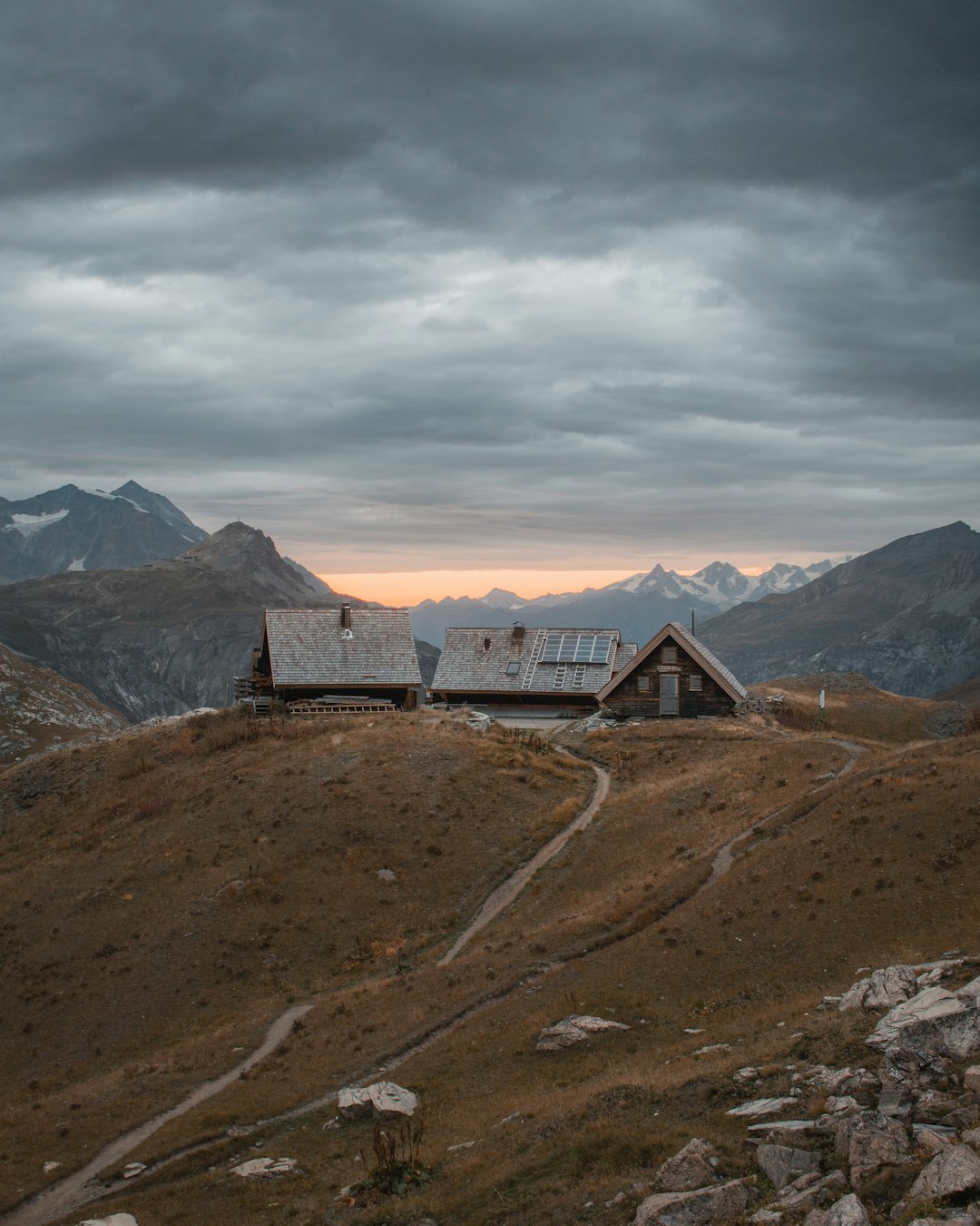 brown house on high ground under gray sky