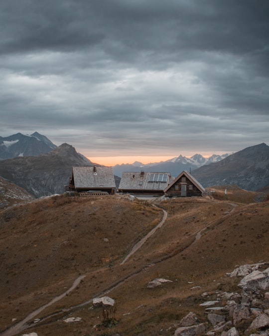 brown house on high ground under gray sky in Val-d'Isère France