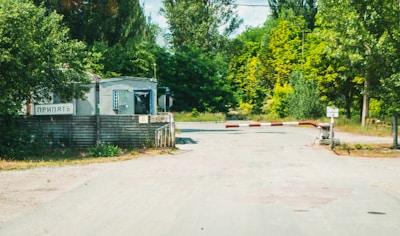 A border checkpoint with officials inspecting agricultural exports under a green canopy.